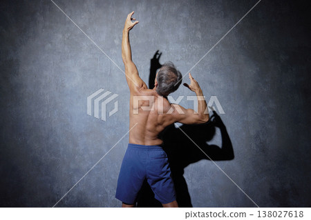Muscular senior man posing, back view Muscular senior man posing, back view 138027618