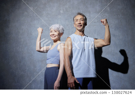 Senior men and women exercising, fist pump, black background Senior men and women exercising, fist pump, black background 138027624