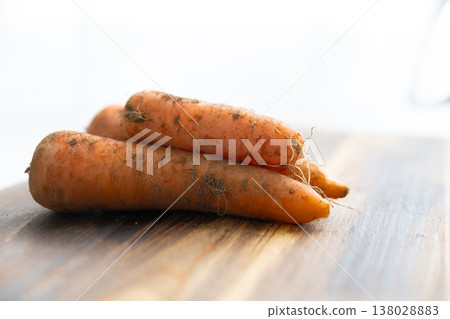 Organic carrots with soil still attached Organic carrots with soil still attached 138028883