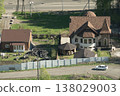 Aerial View Of Suburban Homes With Garden, Gazebo And Parked Car On Quiet Street 138029003