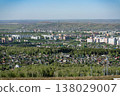 Panoramic View Of Suburban Residential Neighborhood With Apartment Blocks, Houses And Forested Hills 138029007