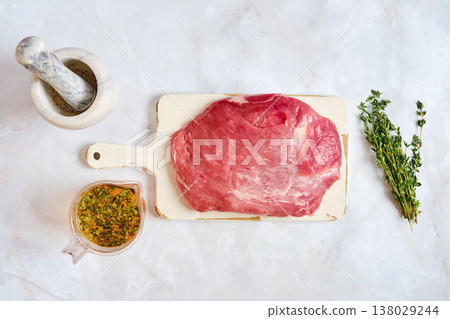 Preparation of pork shoulder for cooking with fresh herbs and seasoning mix Preparation of pork shoulder for cooking with fresh herbs and seasoning mix 138029244