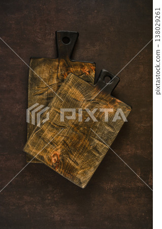 Cutting boards placed on a dark surface for food preparation in a kitchen setting Cutting boards placed on a dark surface for food preparation in a kitchen setting 138029261