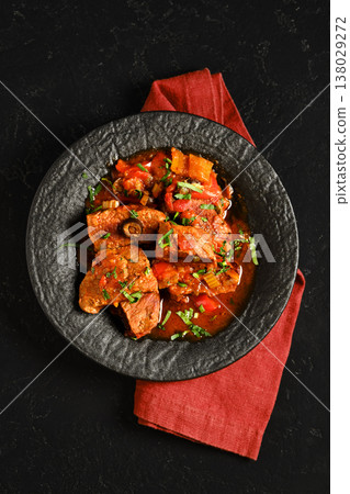 Beef stew served in a bowl with herbs and vegetables on a textured tablecloth Beef stew served in a bowl with herbs and vegetables on a textured tablecloth 138029272