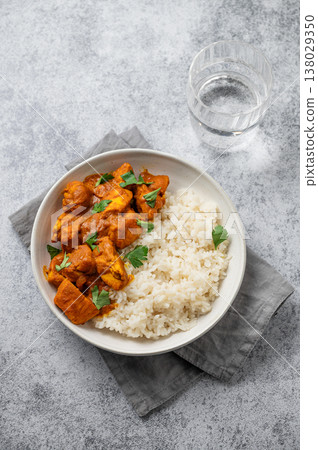 Chicken tikka masala curry with rice on concrete background Chicken tikka masala curry with rice on concrete background 138029350