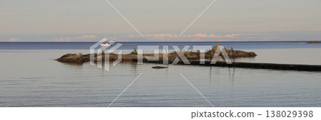 Rock formation named The Nose, jetty and horizon line of Lake Vanern, Sweden. Rock formation named The Nose, jetty and horizon line of Lake Vanern, Sweden. 138029398