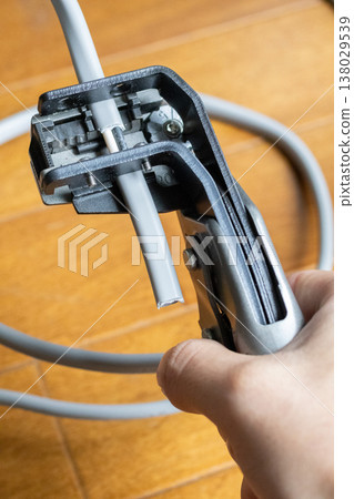 Strip the insulation from the VVF cable with a wire stripper. Strip the insulation from the VVF cable with a wire stripper. 138029539
