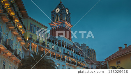 Sunset Town, Phu Quoc, Vietnam. Sunset Town Clock Tower with Pastel Colonial Facades and Glowing Public Sculpture, Sunset Town, Phu Quoc, Vietnam. Sunset Town Clock Tower with Pastel Colonial Facades and Glowing Public Sculpture, 138029618