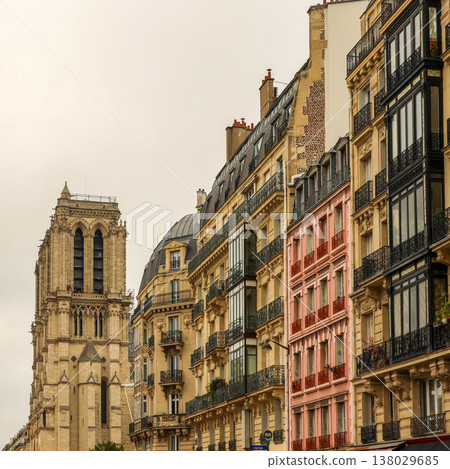 Notre Dame Cathedral tower rising above classic Haussmann buildings and Parisian street architecture Notre Dame Cathedral tower rising above classic Haussmann buildings and Parisian street architecture 138029685