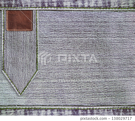 Gray denim texture with a seam and leather label. Light grey color denim jeans material and vintage tag. Denim fabric is a gray shade, with a vintage-inspired tag. Mock up template. Copy space 138029717