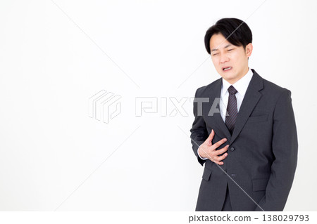 A middle-aged businessman in a suit suffering from pain in his right side. A middle-aged businessman in a suit suffering from pain in his right side. 138029793