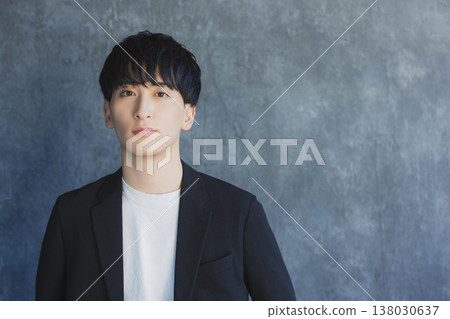 A young man smiling looking at the camera 138030637