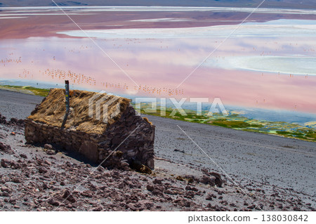 Awe inspiring stone hut by Laguna Colorada colorful lake in Bolivia Awe inspiring stone hut by Laguna Colorada colorful lake in Bolivia 138030842