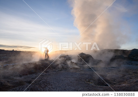 Silhouette in awe at sol de manana over geothermal geyser 138030888
