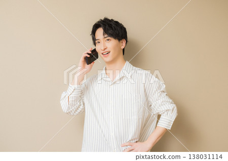 A young man looking at his smartphone A young man looking at his smartphone 138031114