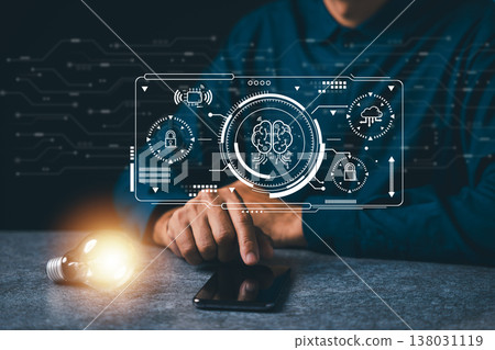 Bulb glowing bright near hand using smartphone shows ai innovation bulb idea, technology business concept featuring digital brain icon, cloud computing and data security graphics 138031119