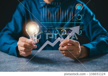 Business idea growth concept using lightbulb hand marketing solution, businessman shows successful progress with data analysis charts and upward rising light bulb arrow for ideas Business idea growth concept using lightbulb hand marketing solution, businessman shows successful progress with data analysis charts and upward rising light bulb arrow for ideas 138031124