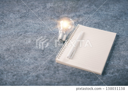Bright bulb light shows creative idea concept, knowledge for education, blank book notebook with pen helps people learn, learning innovation and business training inspires growth 138031138