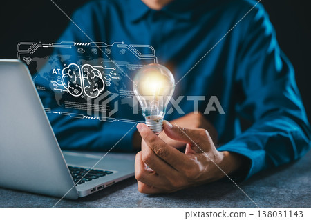 Light glowing bulb illuminates AI innovation concept, person holds bright lightbulb over laptop screen, showing digital brain technology for creative business future tech ideas Light glowing bulb illuminates AI innovation concept, person holds bright lightbulb over laptop screen, showing digital brain technology for creative business future tech ideas 138031143