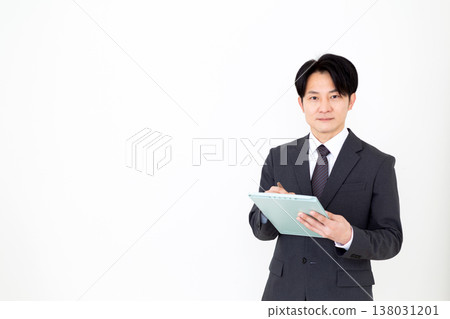 A middle-aged businessman with a binder. 138031201
