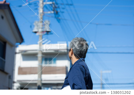 Workers walking through a residential area Workers walking through a residential area 138031202