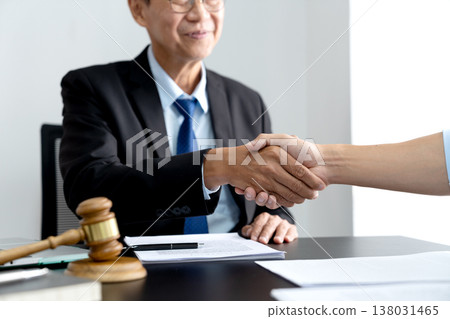 Legal counsel lawyer and client shaking hands to congratulate Legal counsel lawyer and client shaking hands to congratulate 138031465