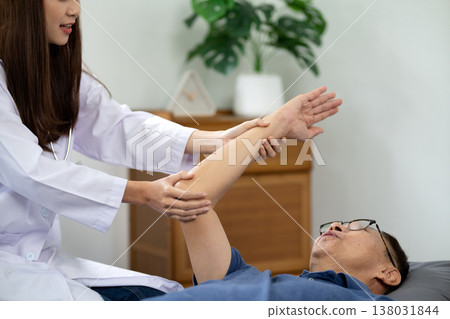 Asian young woman physiotherapist doing postures to cure and alleviate elderly Asian young woman physiotherapist doing postures to cure and alleviate elderly 138031844