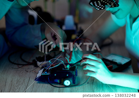 Young man and young woman amateur inventor testing device Young man and young woman amateur inventor testing device 138032248