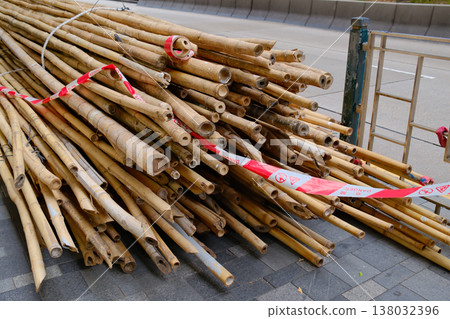 Closeup of tied bamboo scaffolding poles bundle with rope in Hong Kong construction urban street scene 138032396