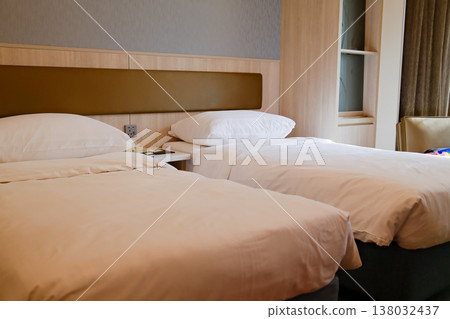 Clean twin bed hotel room with white pillows and neutral interior design in Hong Kong accommodation Clean twin bed hotel room with white pillows and neutral interior design in Hong Kong accommodation 138032437