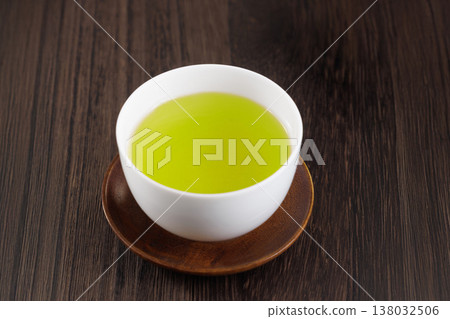 A teacup filled with green tea A teacup filled with green tea 138032506
