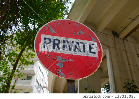 Vintage red round private sign on pole against building and trees in Hong Kong street Vintage red round private sign on pole against building and trees in Hong Kong street 138033083