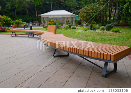 Modern wooden bench on stone base in Hong Kong park seating area Modern wooden bench on stone base in Hong Kong park seating area 138033106