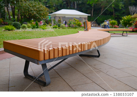 Modern wooden bench on stone base in Hong Kong park seating area 138033107