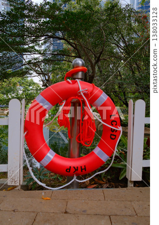 Red lifebuoy on fence near water in Hong Kong park safety equipment Red lifebuoy on fence near water in Hong Kong park safety equipment 138033128