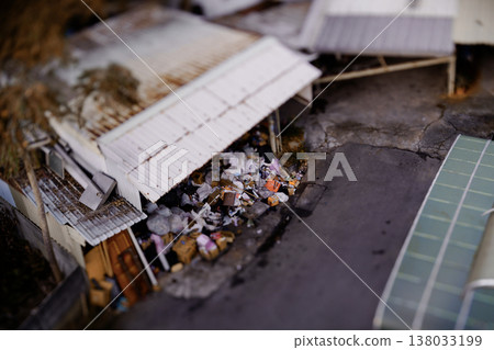 Tilt-shift photography of a tin-roofed shack and piles of debris at a recycling center in Taiwan. 138033199