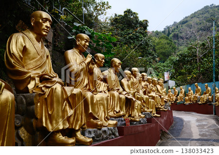 Golden Buddha statues along the stairs in the Ten Thousand Buddhas Monastery, Hong Kong Golden Buddha statues along the stairs in the Ten Thousand Buddhas Monastery, Hong Kong 138033423