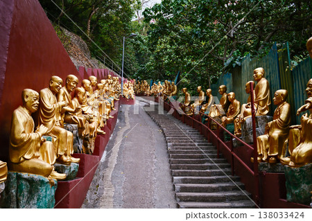 Golden Buddha statues along the stairs in the Ten Thousand Buddhas Monastery, Hong Kong Golden Buddha statues along the stairs in the Ten Thousand Buddhas Monastery, Hong Kong 138033424