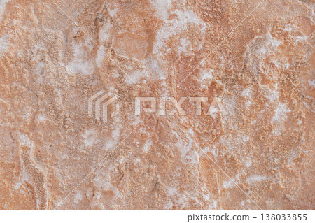 Close-up of natural stone texture with coral and ginger orange tones. Rough rocky surface pattern Close-up of natural stone texture with coral and ginger orange tones. Rough rocky surface pattern 138033855