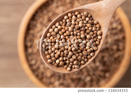 Coriander seeds in a wooden spoon, Top view of Thai food ingredients 138034355