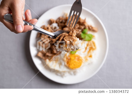 Thai stir-fried pork with garlic, pepper, fried egg and cooked rice Thai stir-fried pork with garlic, pepper, fried egg and cooked rice 138034372