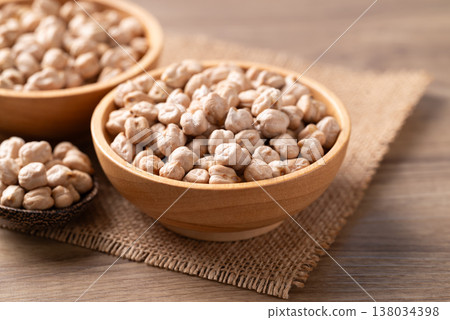 Organic raw chickpeas in a wooden bowl, healthy food ingredient 138034398