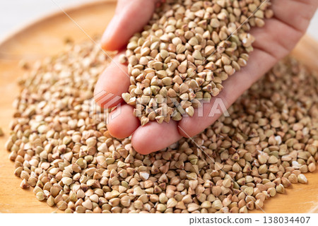 Raw organic buckwheat seeds in hand, Food ingredient Raw organic buckwheat seeds in hand, Food ingredient 138034407