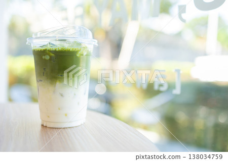Closeup Iced Milk Latte Green Tea, Delight fresh healthy beverage drinks served on the table Closeup Iced Milk Latte Green Tea, Delight fresh healthy beverage drinks served on the table 138034759