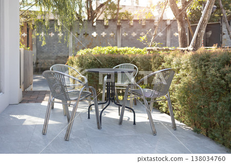 Empty table and chairs setting at outdoor green park garden in the morning cozy meeting space area Empty table and chairs setting at outdoor green park garden in the morning cozy meeting space area 138034760