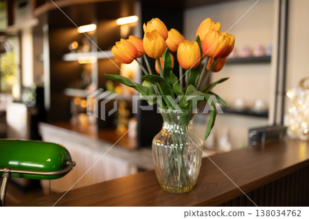 closeup tulips flower decoration at wooden counter in cozy area in cafe or hotel vintage style closeup tulips flower decoration at wooden counter in cozy area in cafe or hotel vintage style 138034762