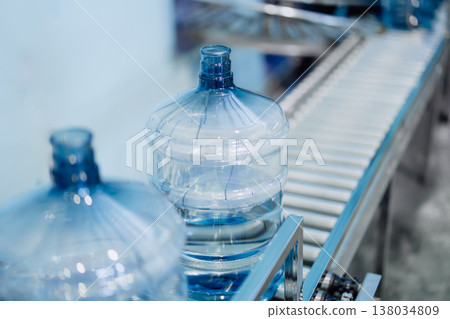 drinking water clean gallon bottles at drinking water factory waiting in line for filling in plant. drinking water clean gallon bottles at drinking water factory waiting in line for filling in plant. 138034809