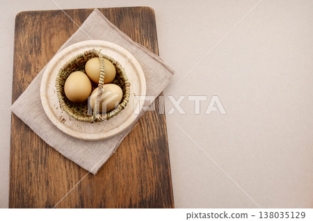 Easter eggs decorated with natural materials, travertine plate and background. 138035129