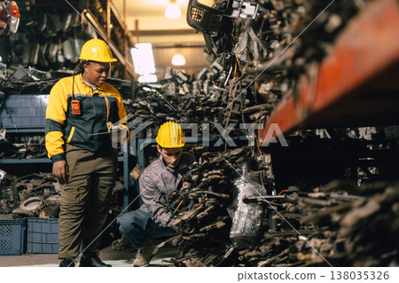 African women with engineer man staff worker working heavy industry old part warehouse African women with engineer man staff worker working heavy industry old part warehouse 138035326