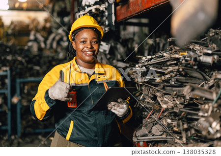 Happy Black African women engineer worker enjoy working in old used machine part stock warehouse. Happy Black African women engineer worker enjoy working in old used machine part stock warehouse. 138035328